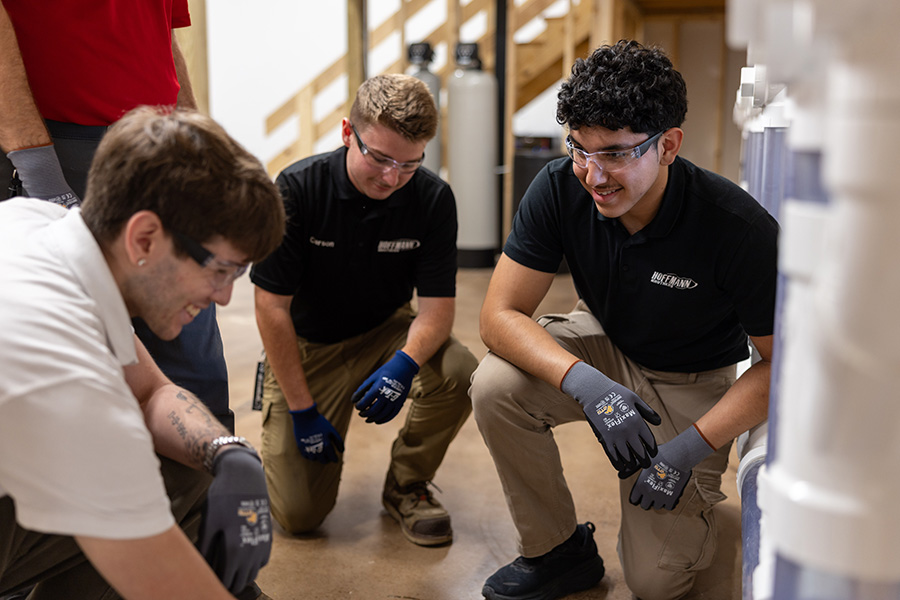 instructor demonstrating a task to a small group of students